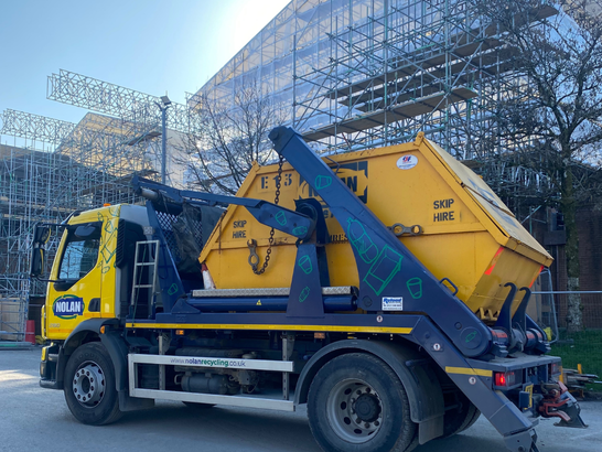 Image of Nolan Recycling enclosed skip on a skip lorry, after collection from the site of the Princess Of Wales Hospital